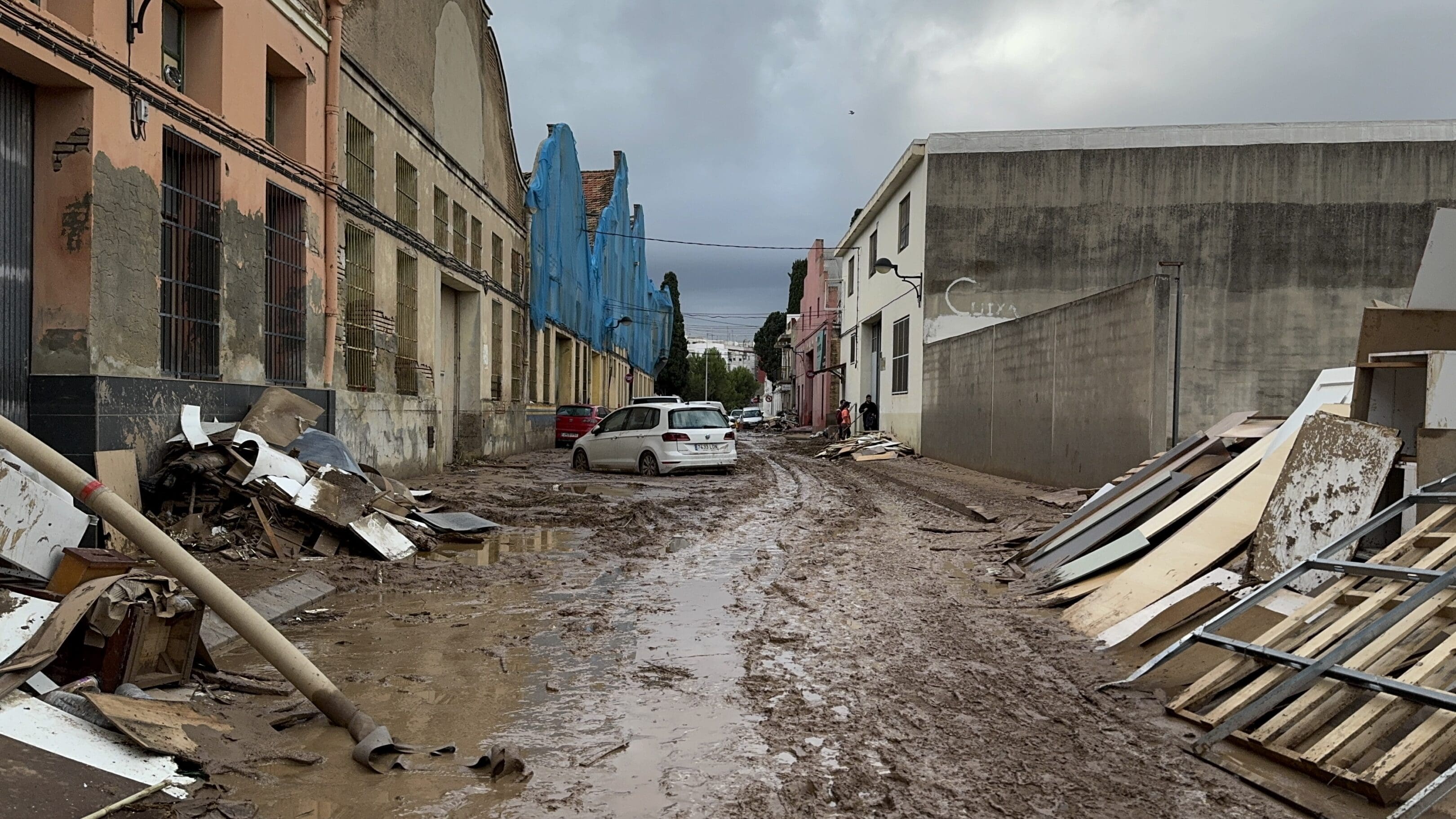 Muddy road with scattered debris.