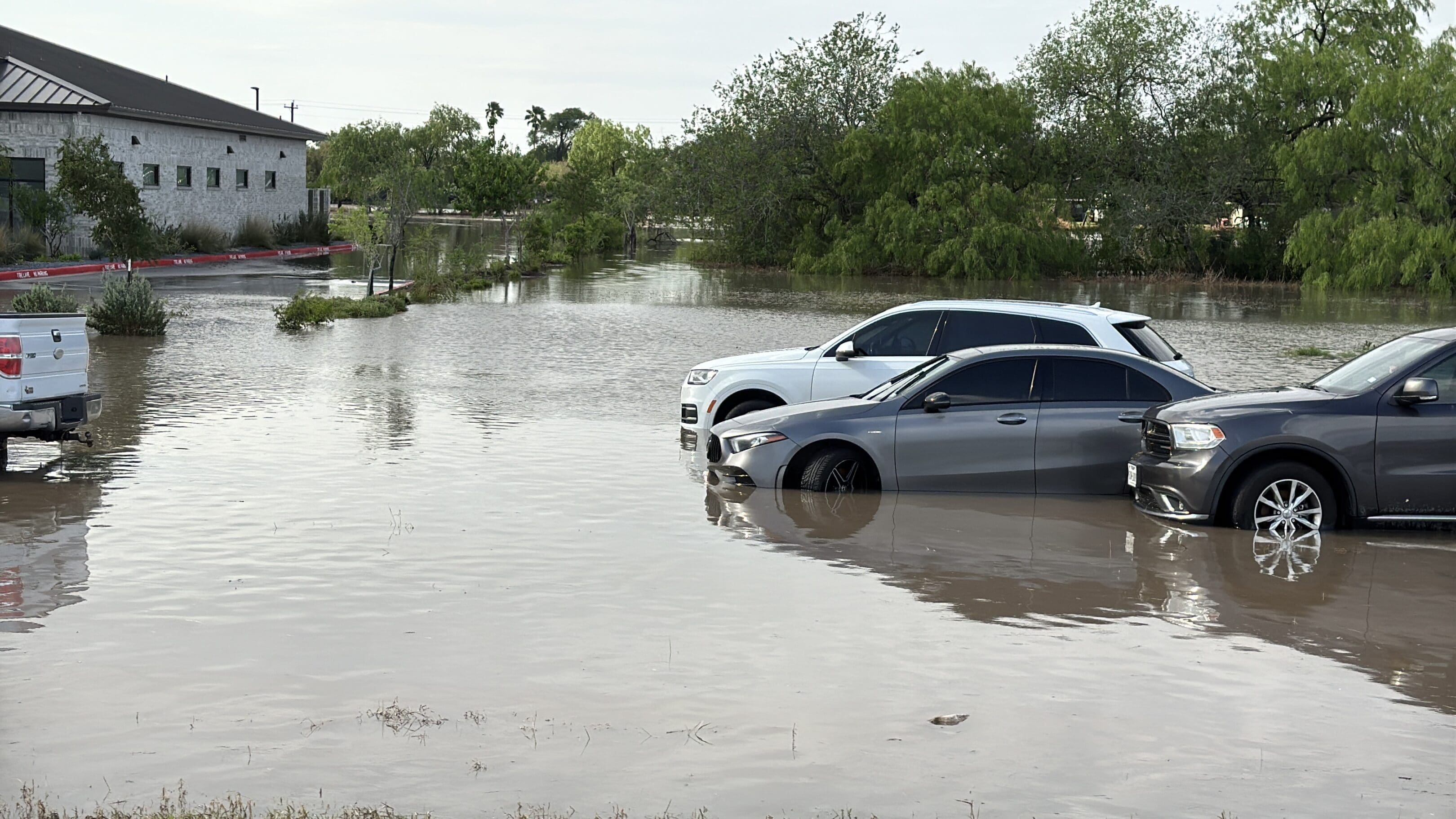 Vehicles caught in a flooded parking lot